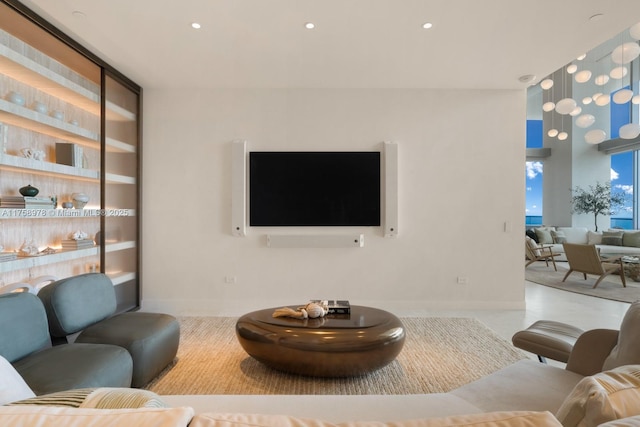 living room featuring baseboards and recessed lighting