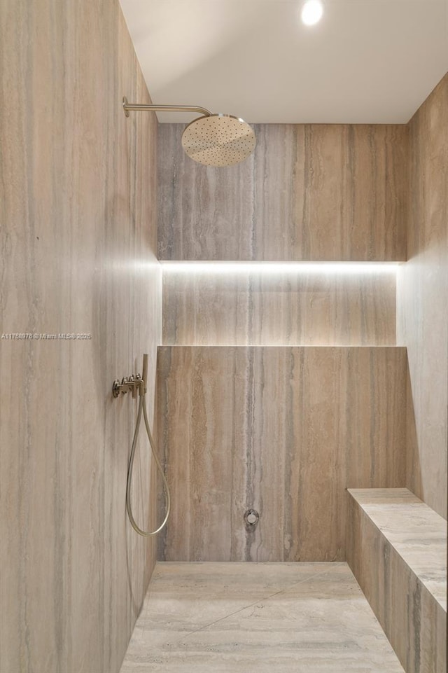 full bath featuring a marble finish shower