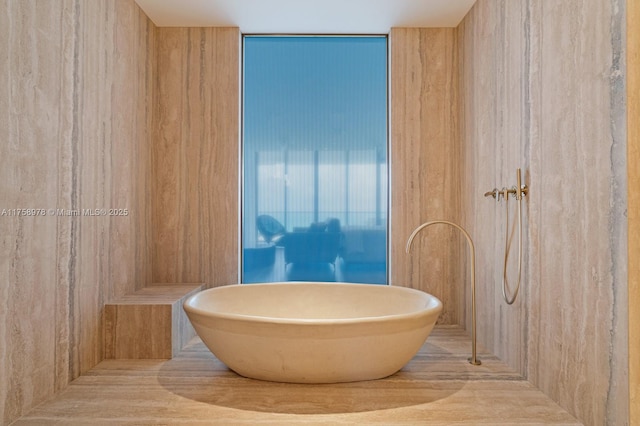 full bathroom featuring a soaking tub