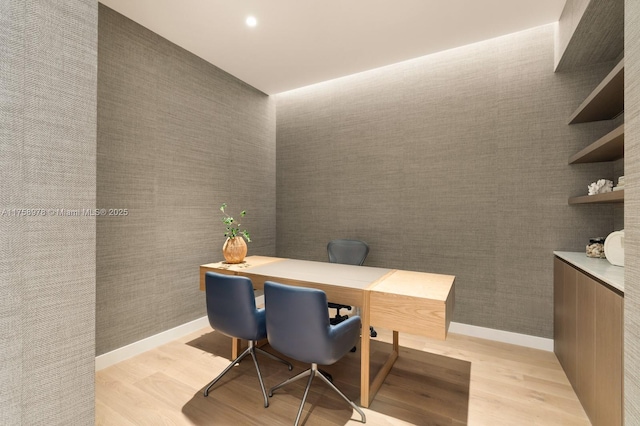 office area with baseboards and light wood-type flooring