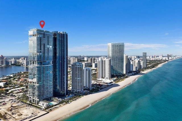 birds eye view of property with a beach view, a city view, and a water view