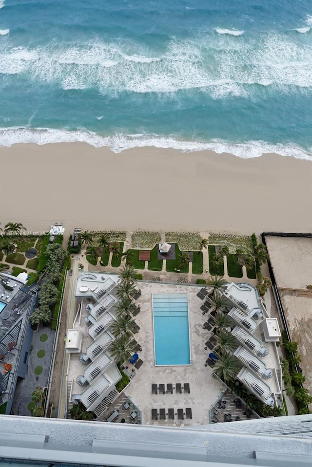 birds eye view of property featuring a beach view and a water view