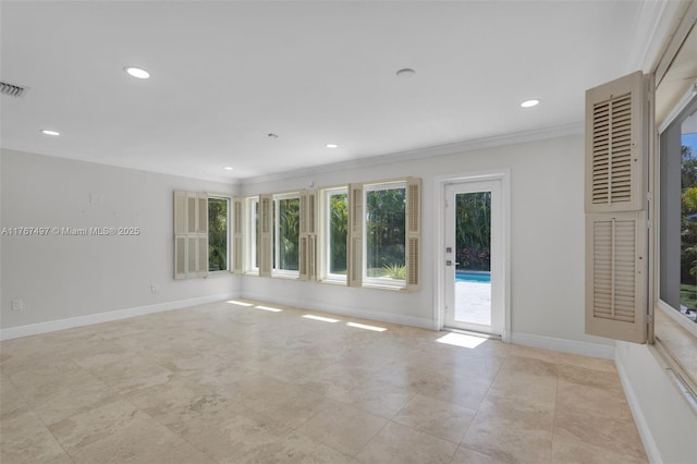 empty room with recessed lighting, crown molding, and baseboards