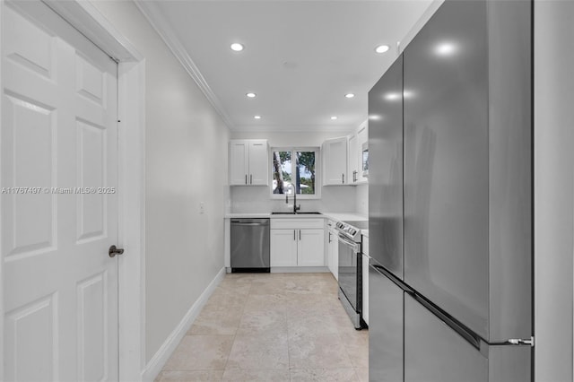 kitchen with ornamental molding, a sink, stainless steel appliances, white cabinets, and light countertops