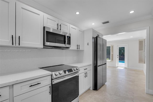 kitchen with white cabinetry, crown molding, visible vents, and stainless steel appliances
