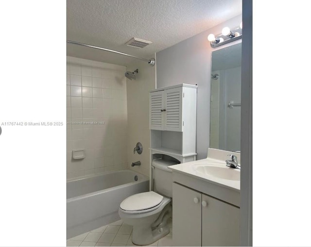 bathroom featuring vanity, visible vents, tile patterned flooring, a textured ceiling, and toilet