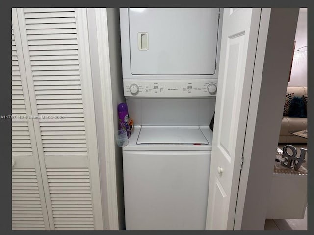 laundry room featuring laundry area and stacked washer / dryer