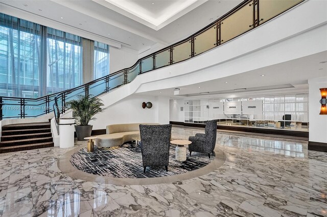 4391 Collins Ave Unit 1618, Miami Beach, FL 33140 - interior space featuring marble finish floor, a towering ceiling, and stairway