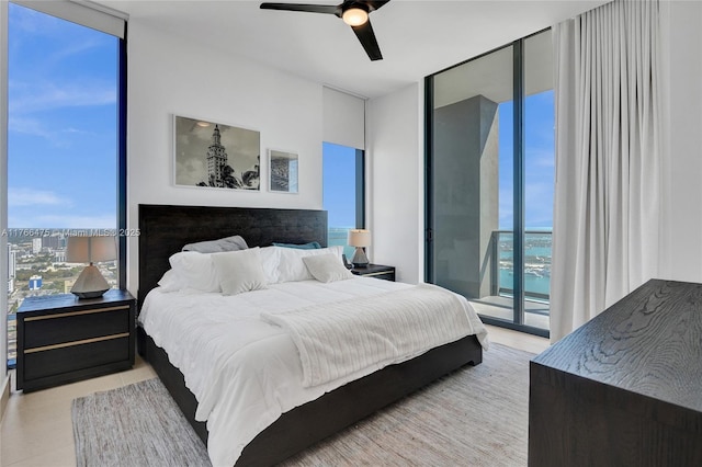 601 NE 1st Ave Unit 5115, Miami, FL 33132 - bedroom with a wall of windows, access to exterior, a ceiling fan, and tile patterned floors
