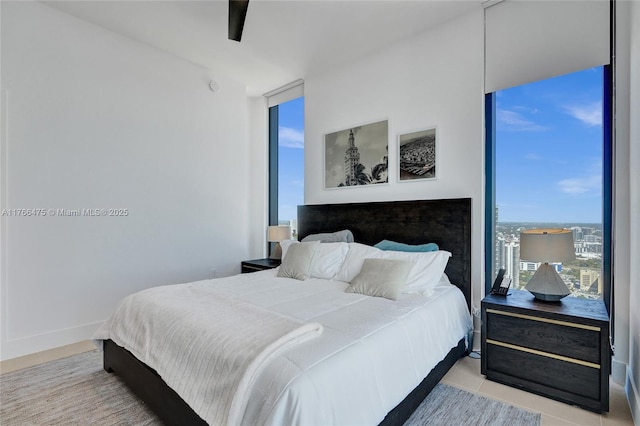 601 NE 1st Ave Unit 5115, Miami, FL 33132 - bedroom featuring floor to ceiling windows, a ceiling fan, and baseboards