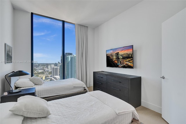 601 NE 1st Ave Unit 5115, Miami, FL 33132 - bedroom with floor to ceiling windows, baseboards, and light tile patterned floors