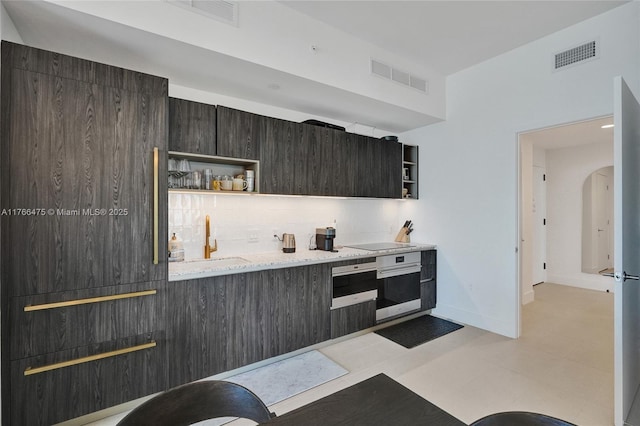 601 NE 1st Ave Unit 5115, Miami, FL 33132 - kitchen with open shelves, stainless steel oven, a sink, black electric stovetop, and backsplash