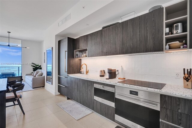 601 NE 1st Ave Unit 5115, Miami, FL 33132 - kitchen with stainless steel oven, open shelves, black electric cooktop, and modern cabinets