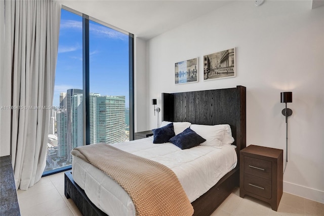 601 NE 1st Ave Unit 5115, Miami, FL 33132 - bedroom featuring floor to ceiling windows, baseboards, and light tile patterned flooring