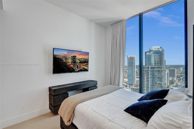 601 NE 1st Ave Unit 5115, Miami, FL 33132 - bedroom featuring multiple windows, baseboards, and a wall of windows