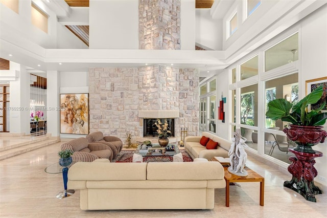665 Leucadendra Dr, Coral Gables, FL 33156 - living area featuring a fireplace and a towering ceiling