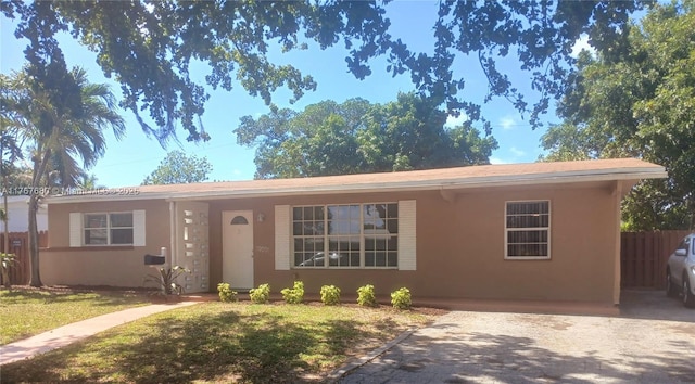 6464 Johnson St, Hollywood, FL 33024 - ranch-style home featuring fence, a front yard, and stucco siding