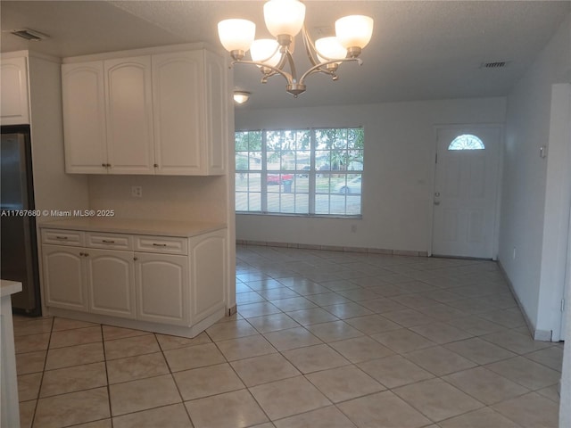 6464 Johnson St, Hollywood, FL 33024 - kitchen with a chandelier, a healthy amount of sunlight, light countertops, and freestanding refrigerator