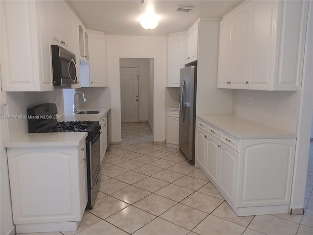 6464 Johnson St, Hollywood, FL 33024 - kitchen featuring white cabinets, visible vents, appliances with stainless steel finishes, and a sink