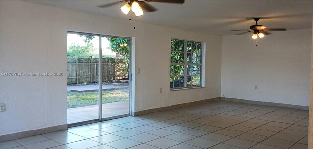 6464 Johnson St, Hollywood, FL 33024 - unfurnished room with baseboards, a ceiling fan, light tile patterned flooring, and plenty of natural light
