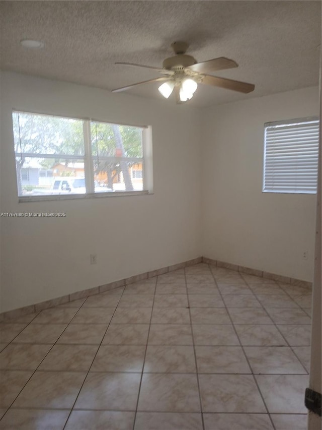 6464 Johnson St, Hollywood, FL 33024 - spare room featuring a textured ceiling, ceiling fan, light tile patterned floors, and baseboards