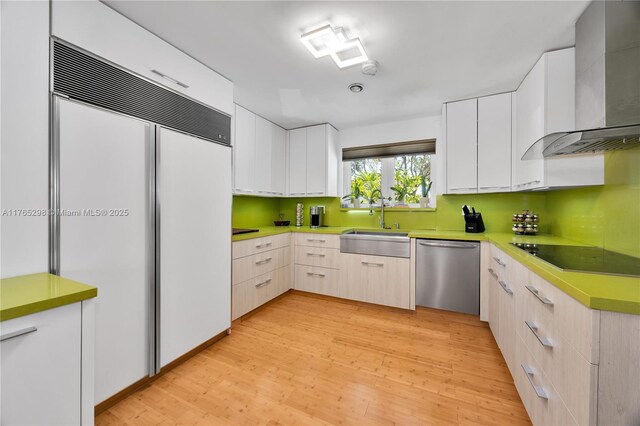 8951 SW 160th St, Palmetto Bay, FL 33157 - kitchen with black electric stovetop, paneled built in fridge, stainless steel dishwasher, wall chimney exhaust hood, and a sink