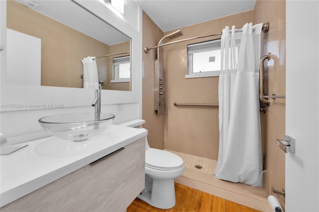 8951 SW 160th St, Palmetto Bay, FL 33157 - full bath with a tile shower, toilet, vanity, and wood finished floors
