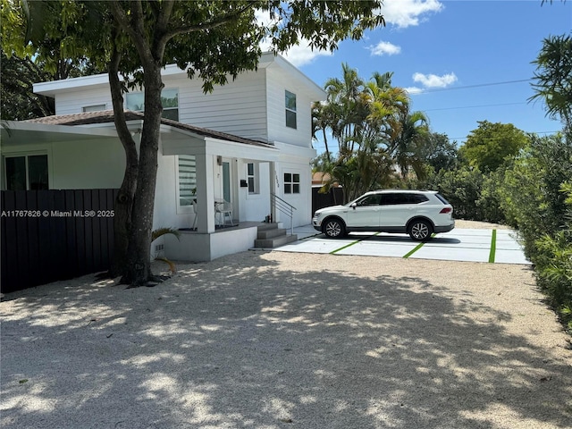 view of front of house with entry steps and fence