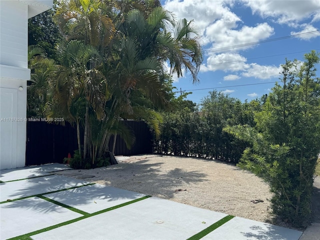 view of yard with fence and a patio