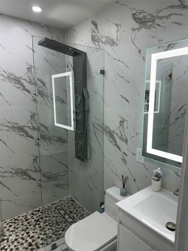 full bath with tile walls, a marble finish shower, toilet, recessed lighting, and vanity