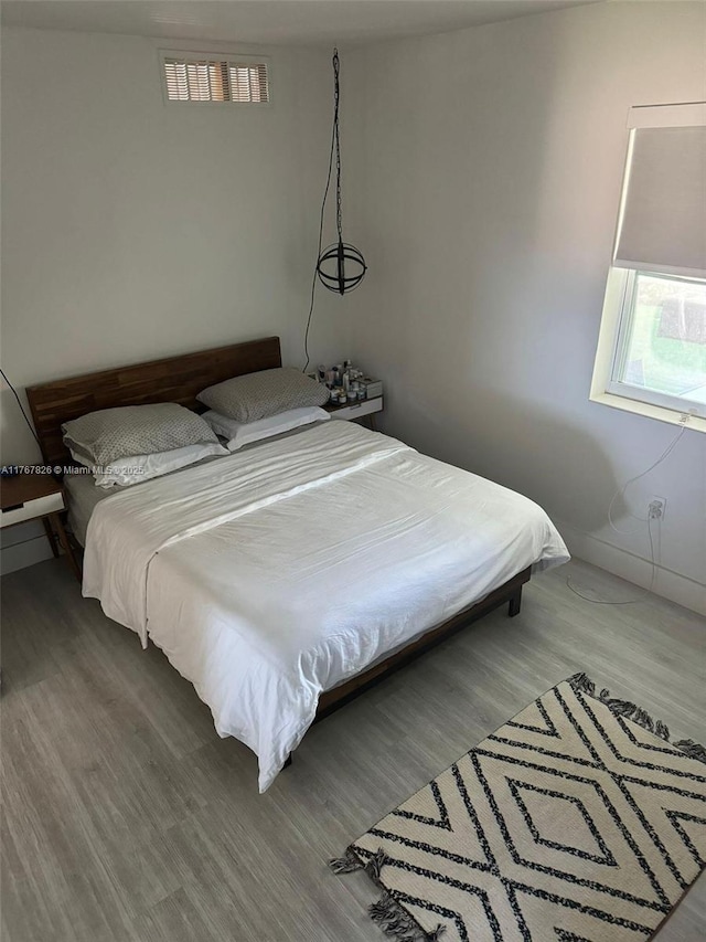 bedroom featuring wood finished floors