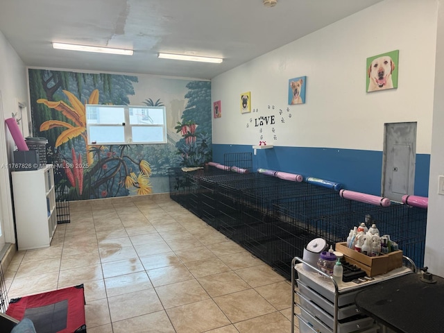 misc room with electric panel and tile patterned floors
