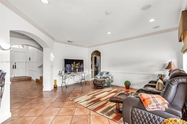 living area with visible vents, crown molding, light tile patterned floors, recessed lighting, and arched walkways