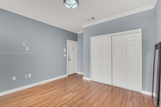 unfurnished bedroom with light wood-type flooring, visible vents, and baseboards