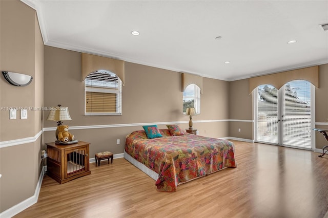 bedroom with wood finished floors, baseboards, recessed lighting, access to exterior, and crown molding
