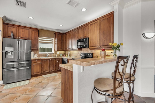 kitchen with visible vents, electric stove, stainless steel fridge, light tile patterned flooring, and black microwave