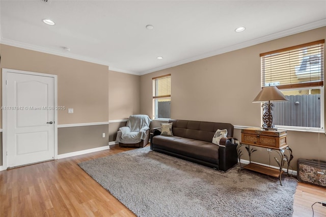 living room featuring recessed lighting, wood finished floors, baseboards, and ornamental molding