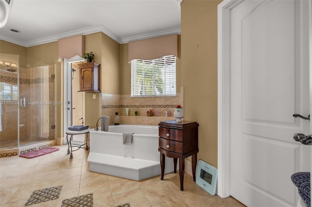 bathroom with a shower stall, a healthy amount of sunlight, a garden tub, and ornamental molding