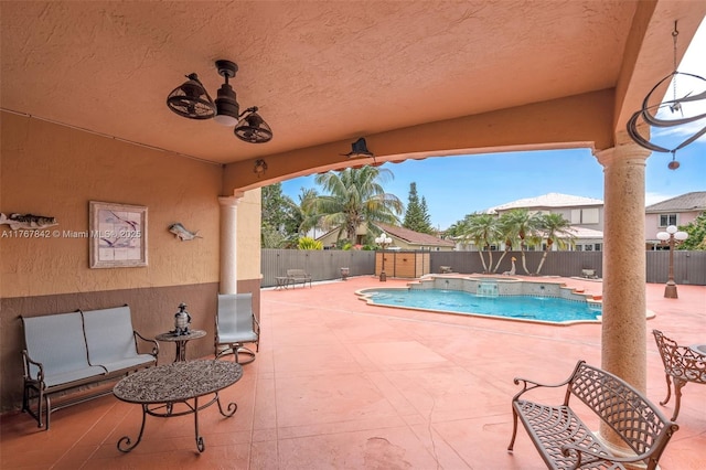 view of pool featuring a pool with connected hot tub, a patio area, and a fenced backyard