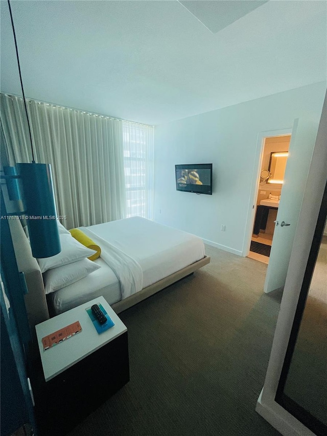 bedroom with baseboards and carpet floors
