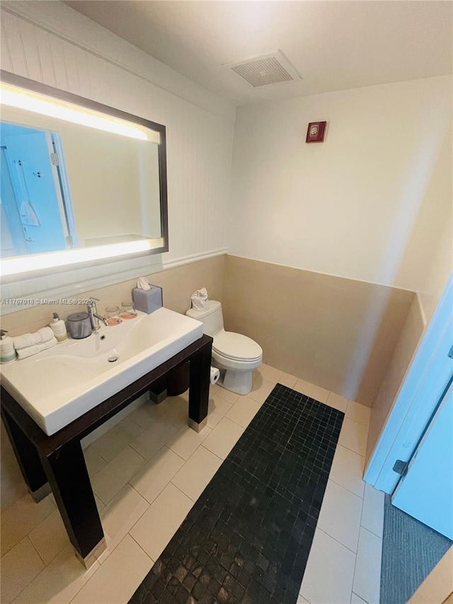 bathroom with tile patterned floors, toilet, and visible vents