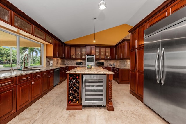 kitchen with lofted ceiling, a sink, decorative backsplash, stainless steel appliances, and wine cooler