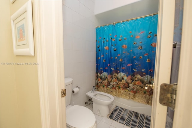 bathroom featuring shower / bathtub combination with curtain, toilet, a bidet, tile walls, and tile patterned flooring