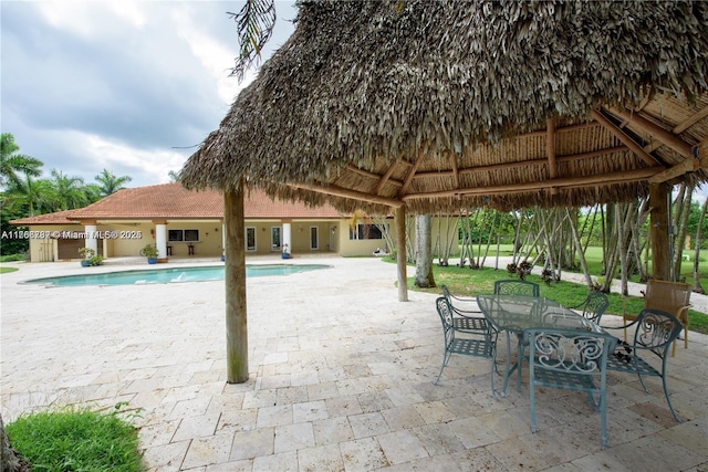 pool with a gazebo and a patio