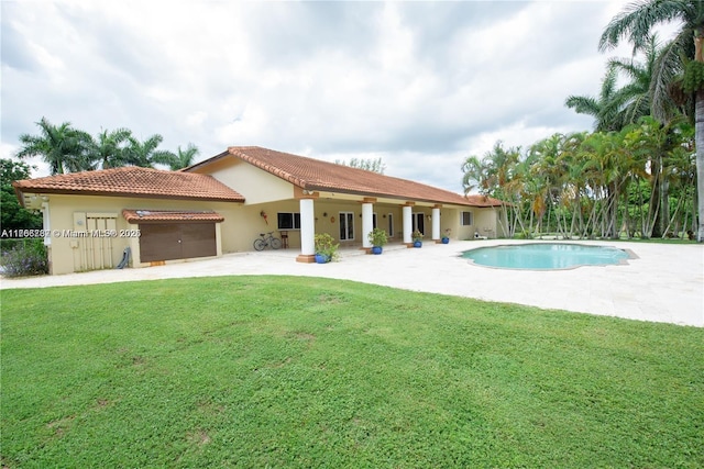 pool with a patio and a lawn