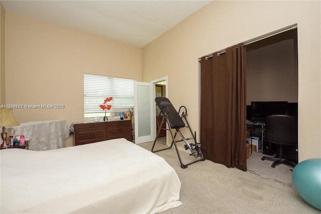 bedroom featuring light carpet