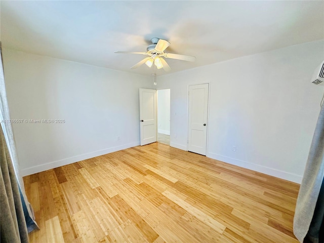 unfurnished bedroom featuring light wood-type flooring, baseboards, and a ceiling fan