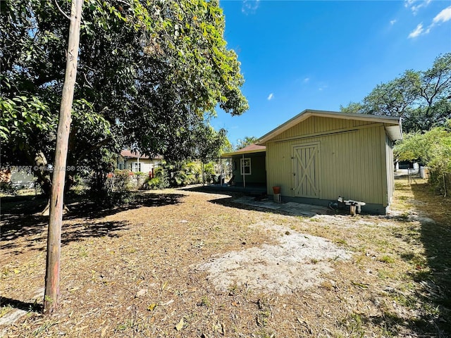 exterior space featuring an outbuilding and fence