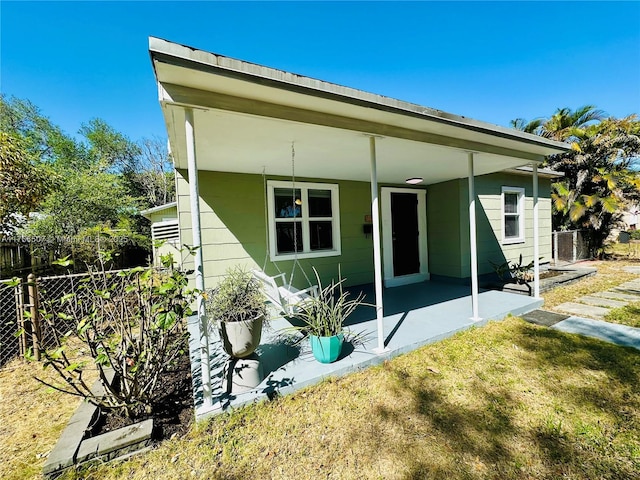 back of house with a patio and fence