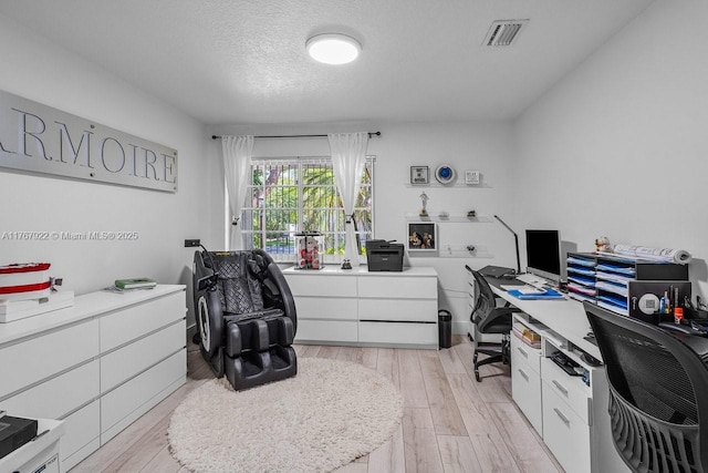 517 Misty Oaks Dr, Pompano Beach, FL 33069 - office area featuring visible vents, light wood-type flooring, and a textured ceiling